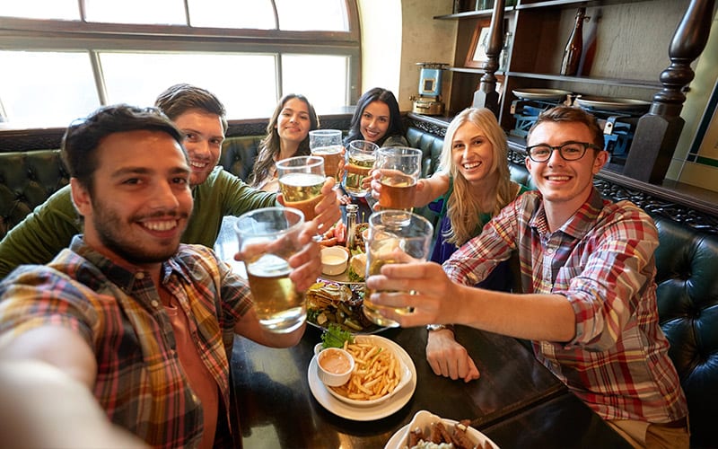 Group of young adults enjoying dinner show experience