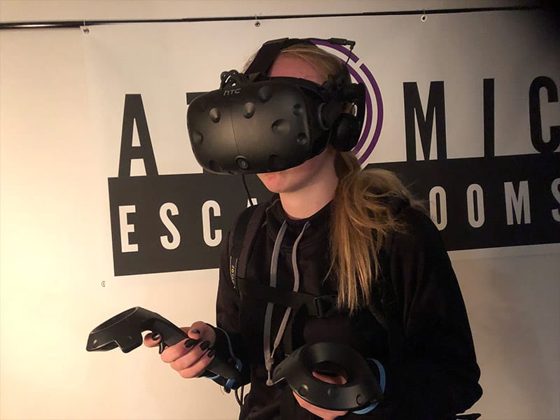 teens playing a virtual reality escape game